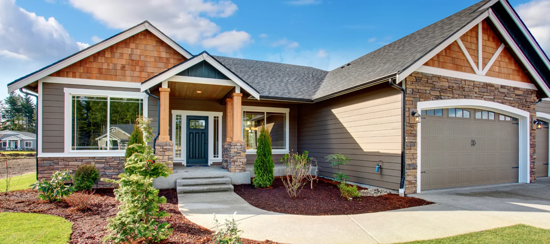 Modern craftsman home with stone accents and a black front door